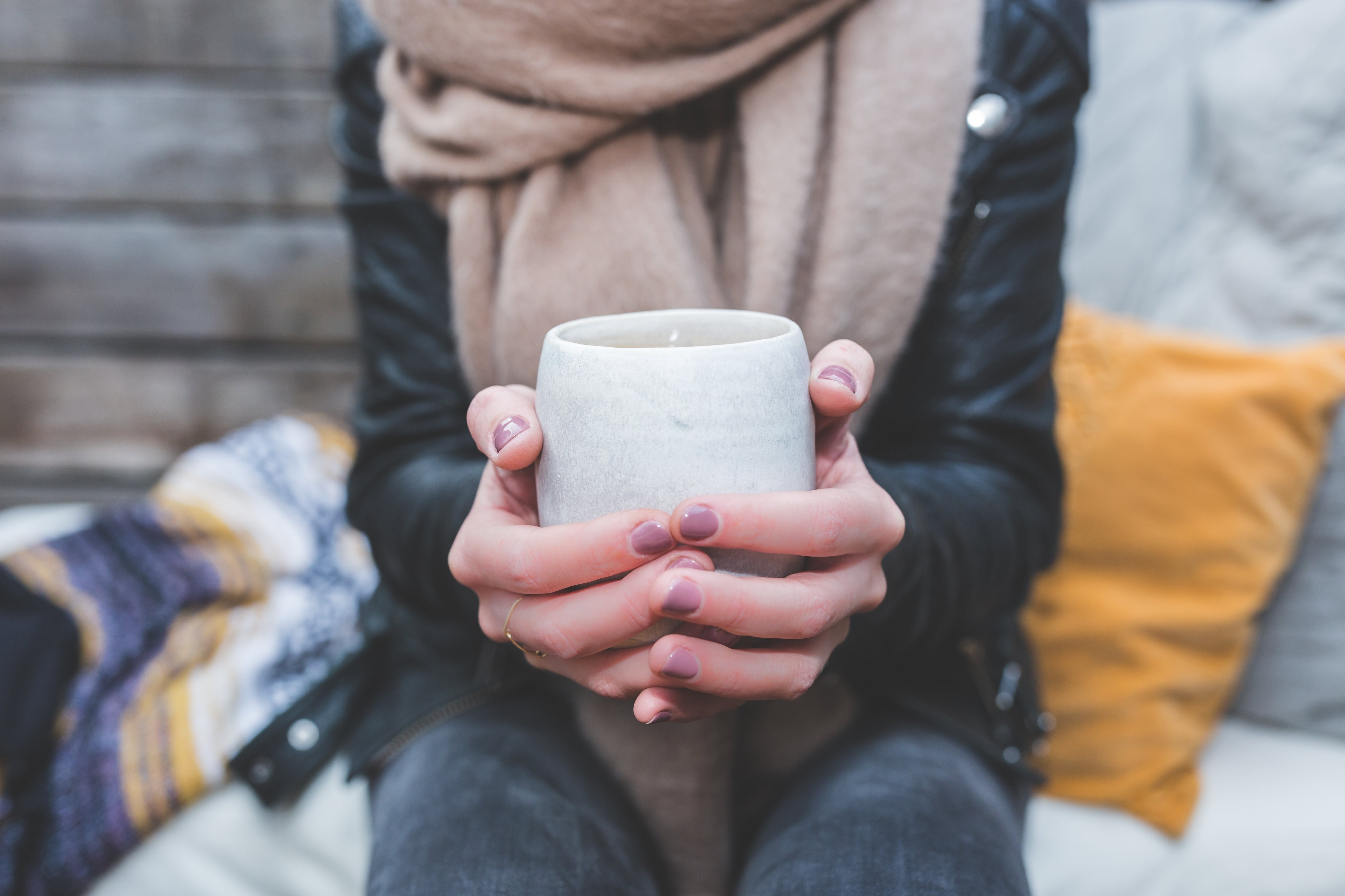 woman's hands holding mug