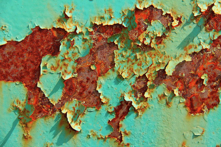 rust and flaking paint on wall